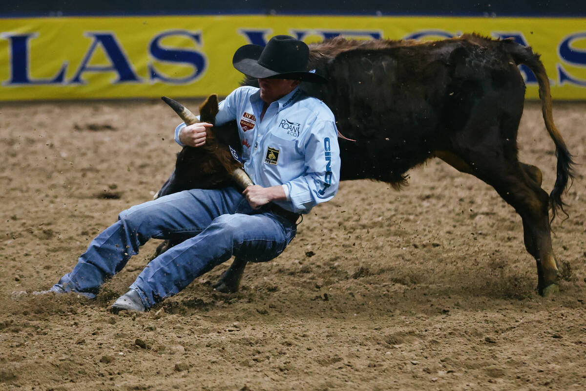 Tucker Allen competes in the steer wrestling event in the 10th go-round of the National Finals ...