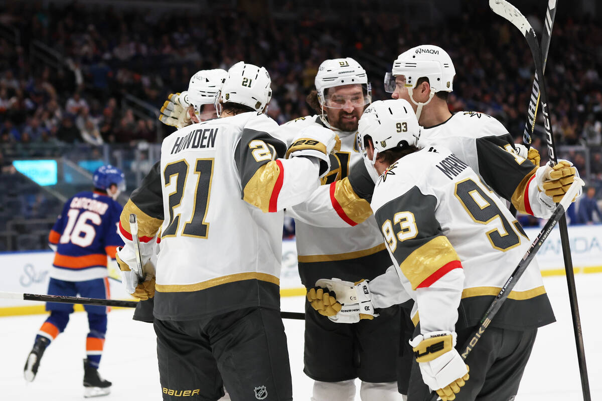 Vegas Golden Knights players celebrate a goal by Mitch Marner (93) during the first period of a ...