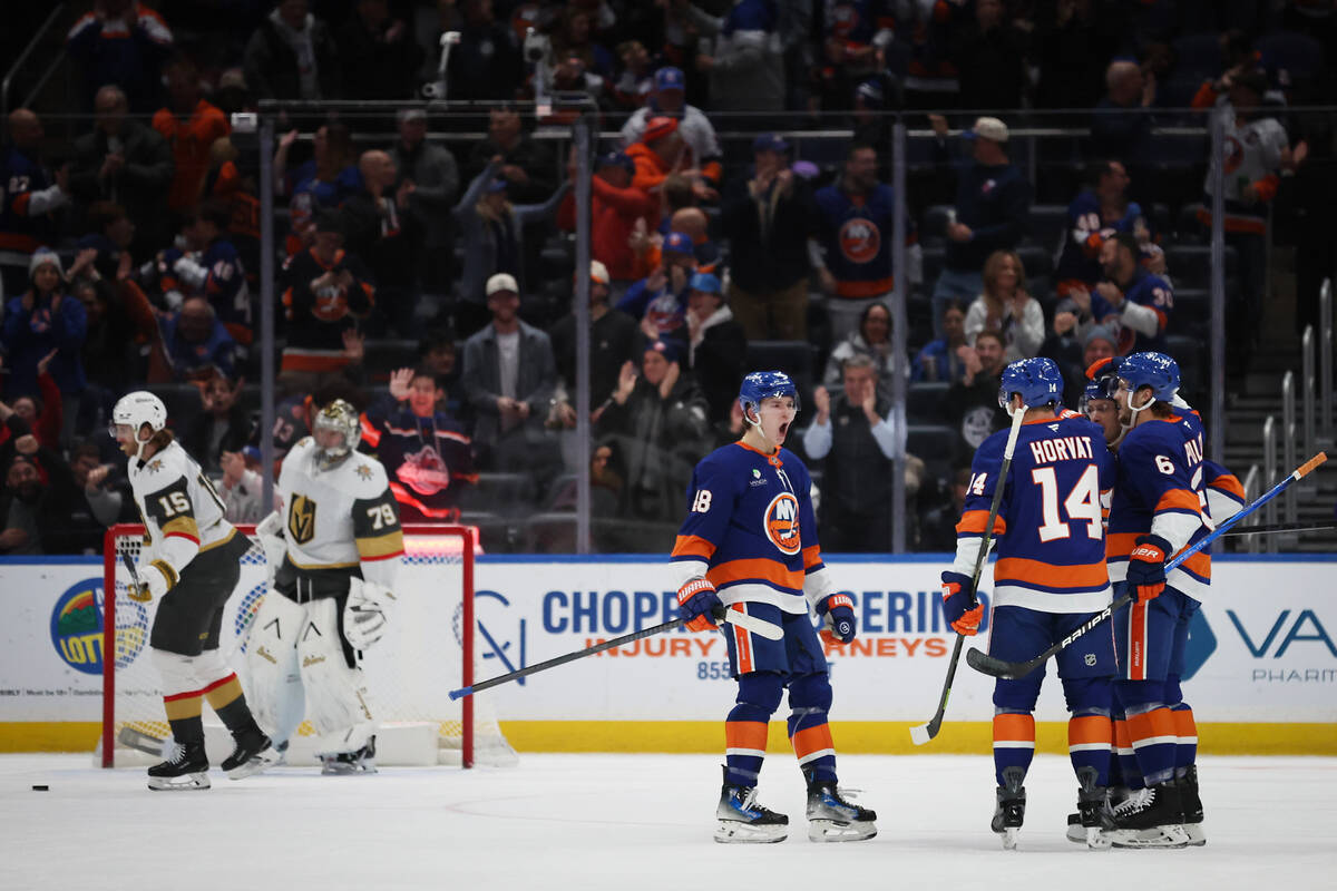 New York Islanders players celebrate a goal by Bo Horvat (14) during the first period of an NHL ...
