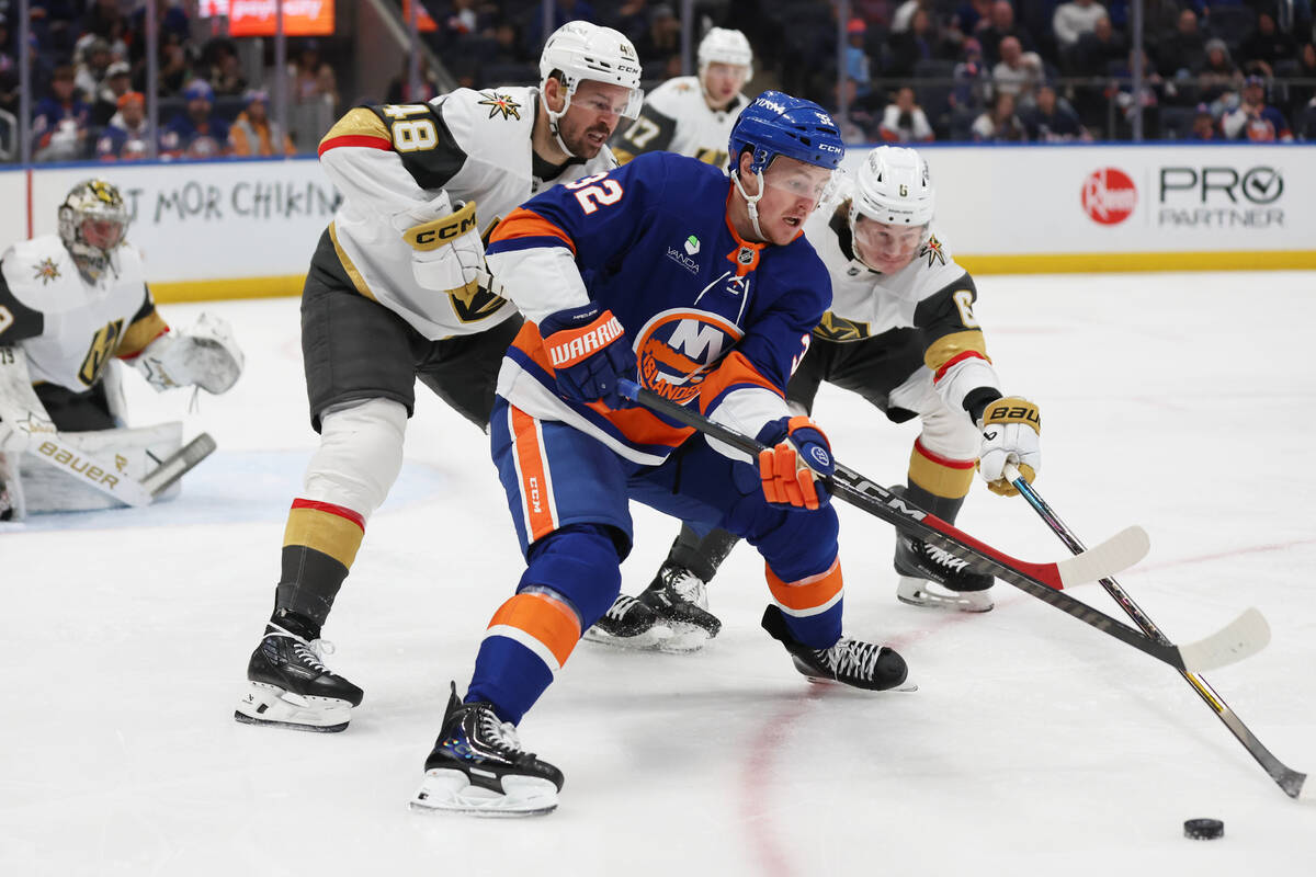 New York Islanders' Kyle MacLean (32) and Vegas Golden Knights' Kaedan Korczak (6) re ...