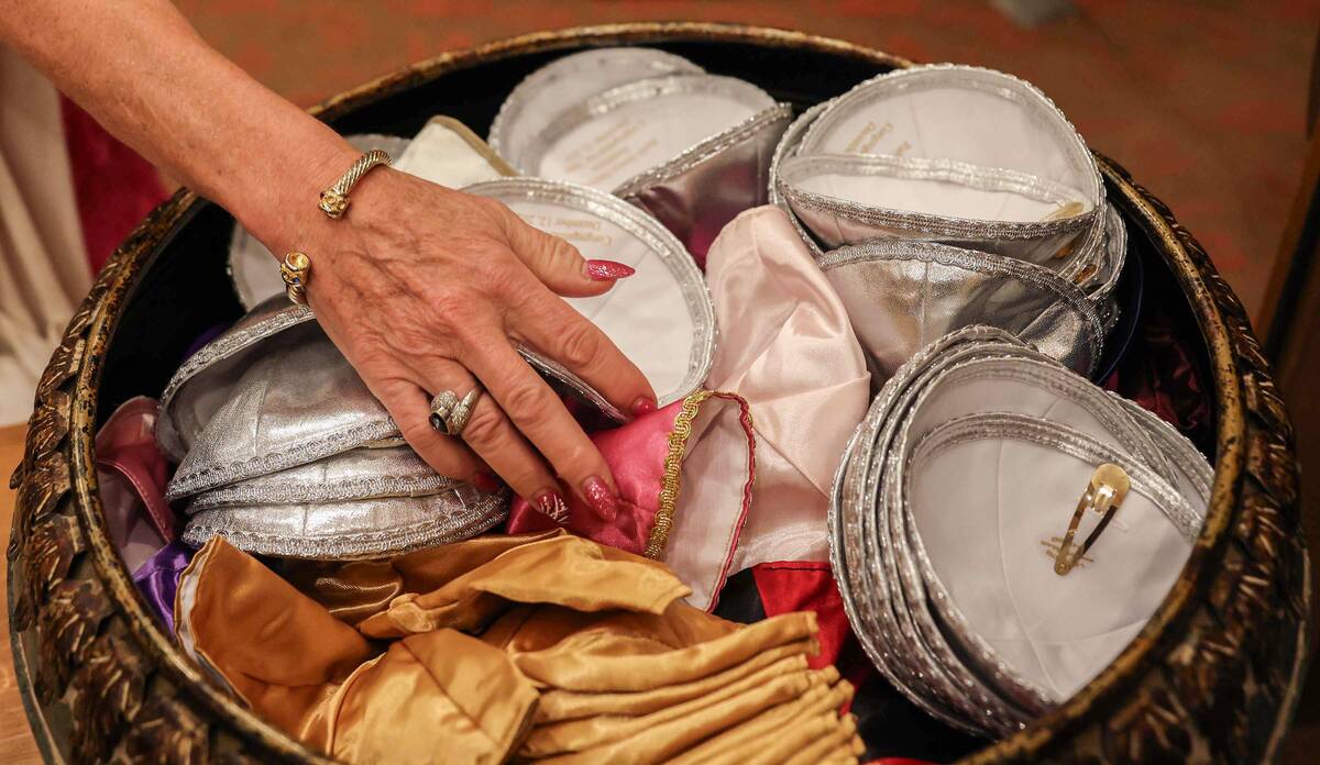 Congregates take yarmulkes before the start of a ceremony to formally install Rabbi-Cantor Jess ...
