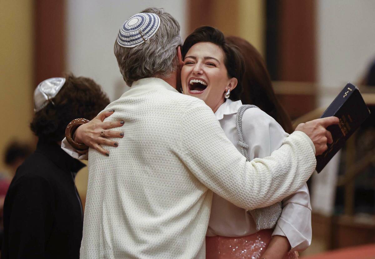 Alana Weinberg, sister of Rabbi-Cantor Jessica Hutchings, hugs relatives during a ceremony to f ...
