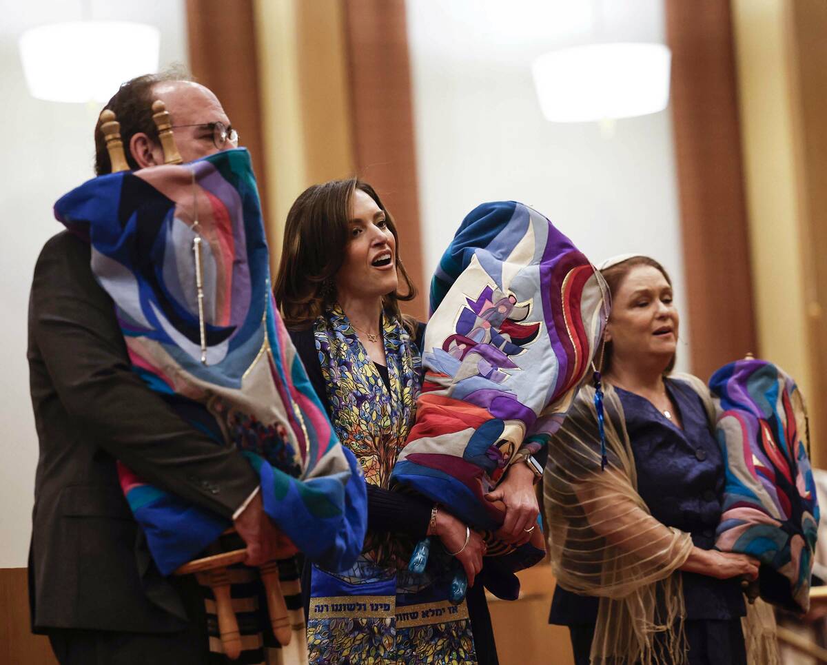 Rabbi-Cantor Jessica Hutchings, middle, sings during a ceremony to formally install her as Cong ...