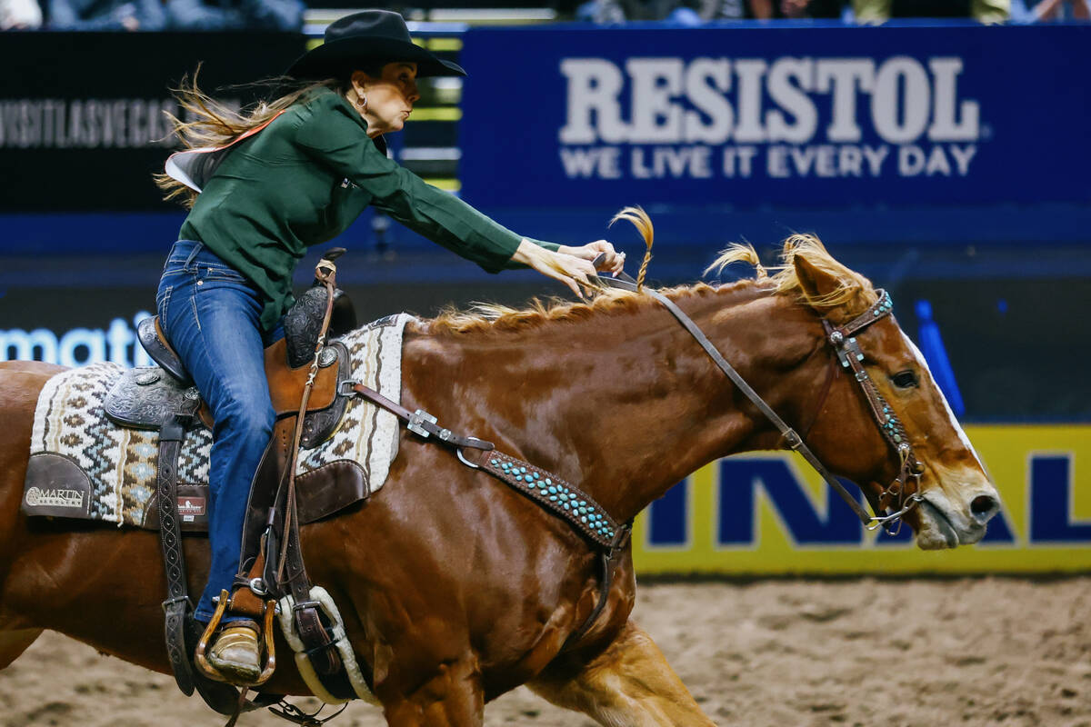 Kassie Mowry competes in barrel racing during the seventh go-round of the National Finals Rodeo ...
