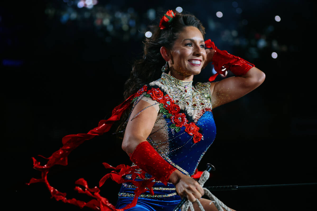 A trick rider zooms by on her horse during the opening ceremony for the seventh go-round of the ...