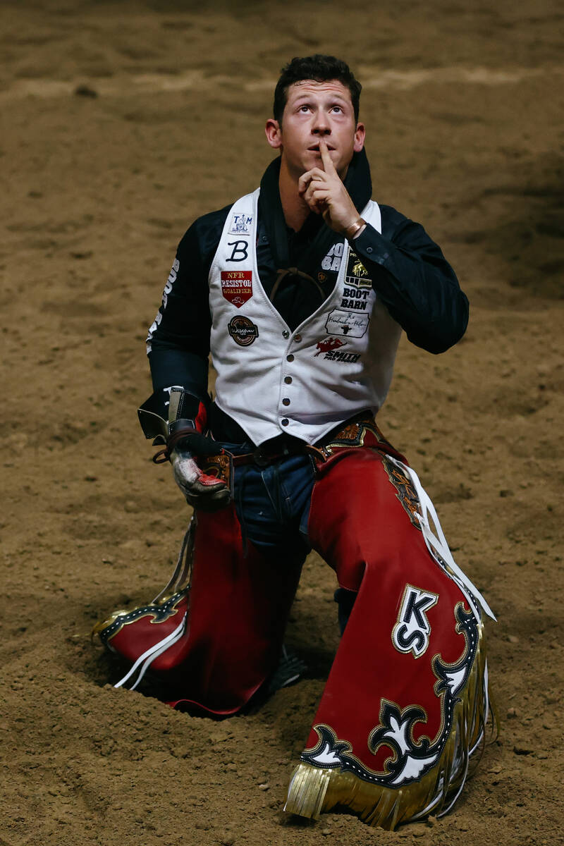 Kade Sonnier does a quick prayer after riding Empty Promises in the bareback riding event durin ...