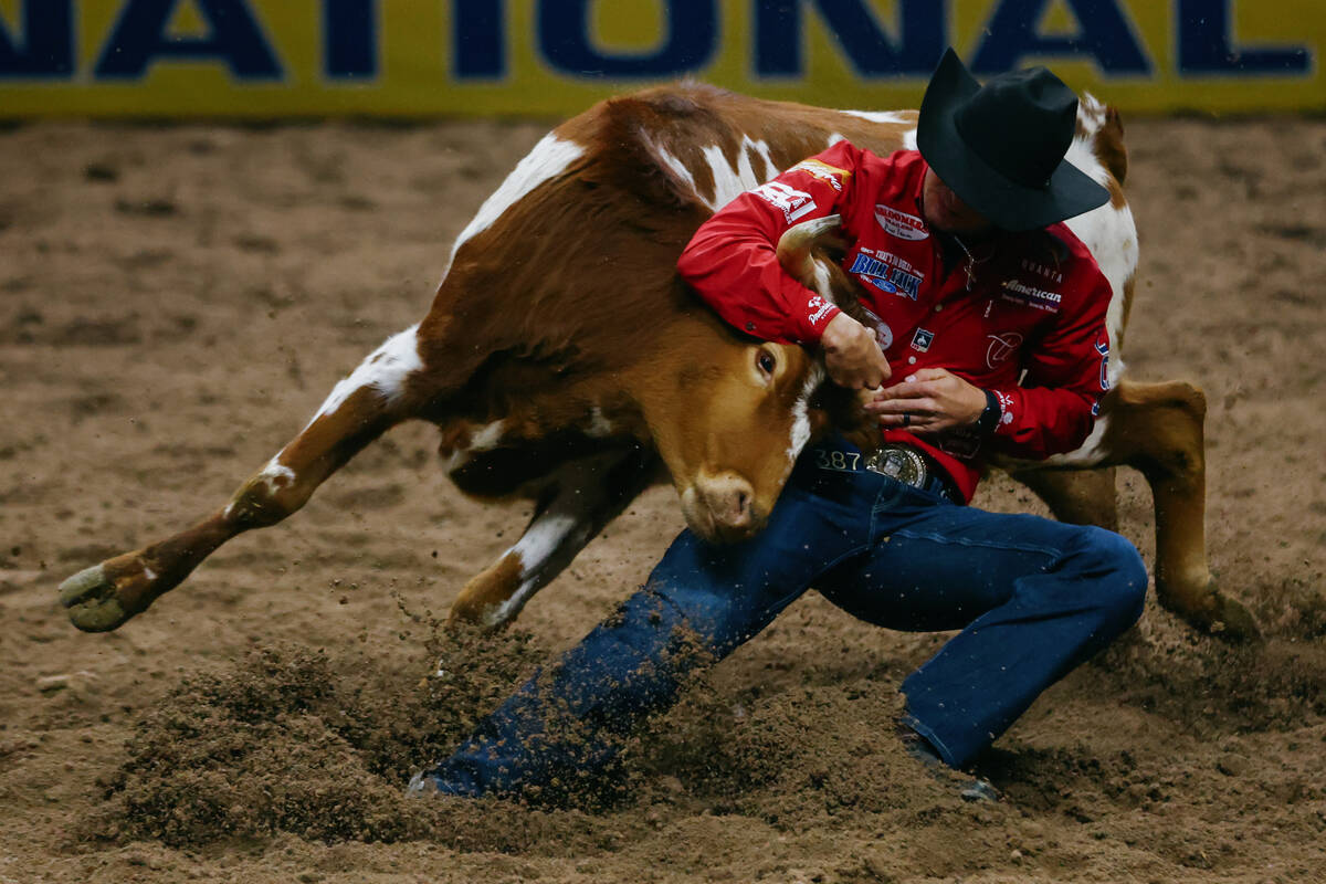 Rowdy Parrott competes in the steer wrestling event during the seventh go-round of the National ...