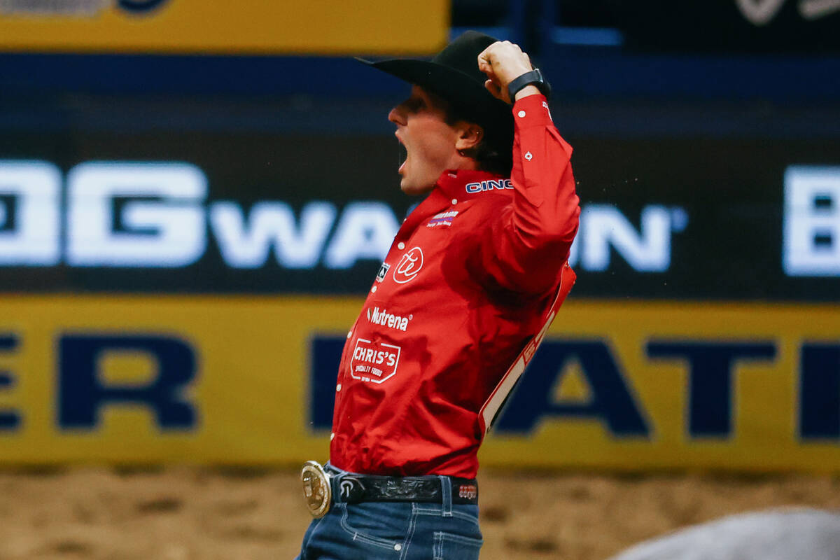 Rowdy Parrott celebrates after getting the best time - 4.0 seconds - in the steer wrestling eve ...
