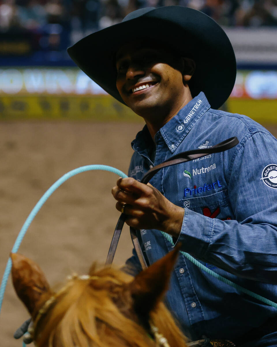 Junior Nogueira grins after competing in the team roping event during the seventh go-round of t ...