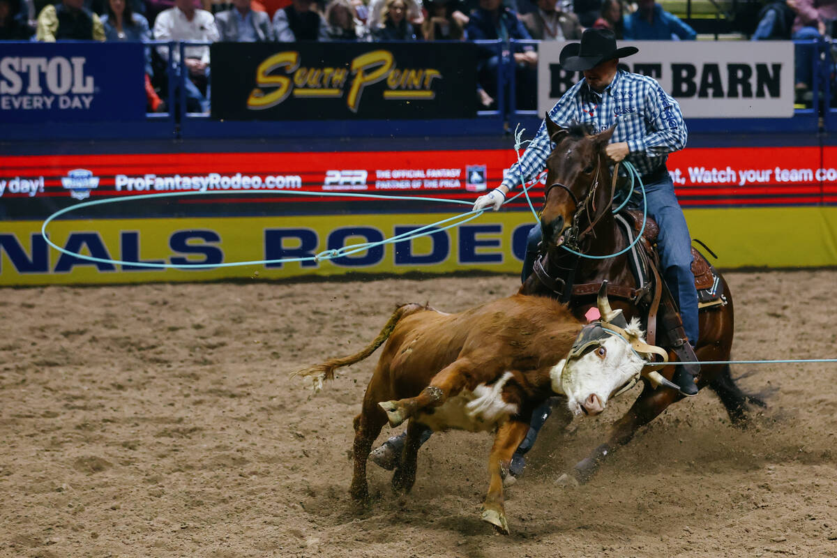 Dillon Graham competes in the team roping event during the seventh go-round of the National Fin ...