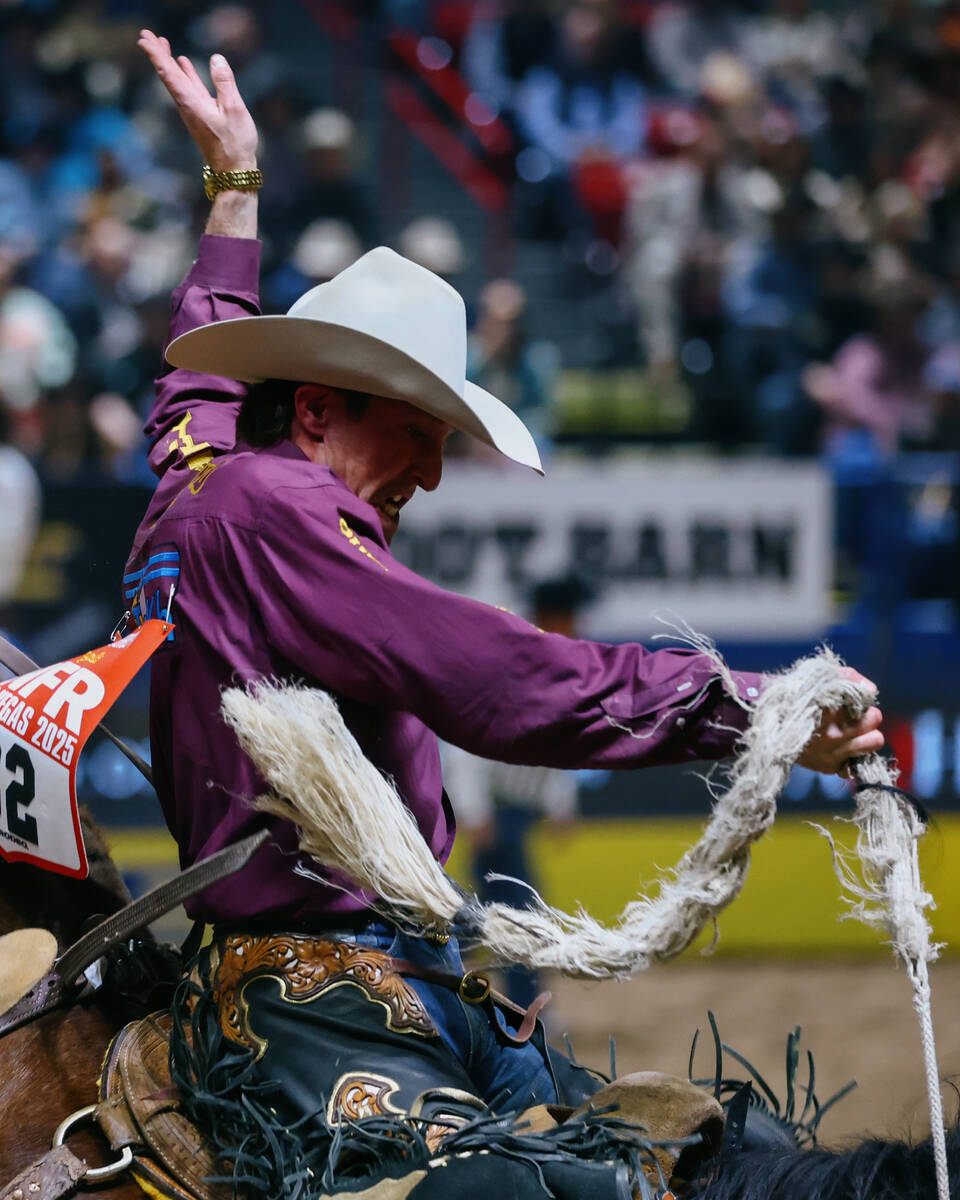 Ben Andersen rides Toma Jo in the saddle bronc riding event during the seventh go-round of the ...