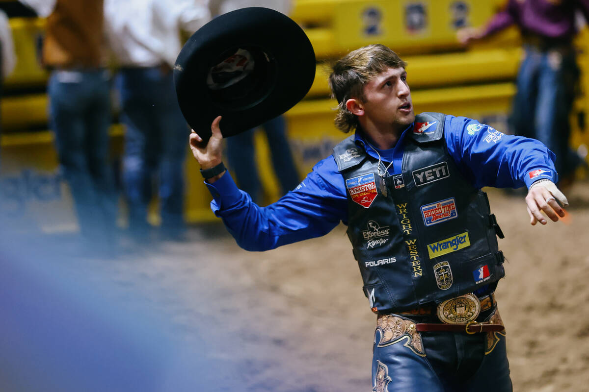 Statler Wright throws his hat in celebration after riding Talk Derby 2 Me in the saddle bronc r ...