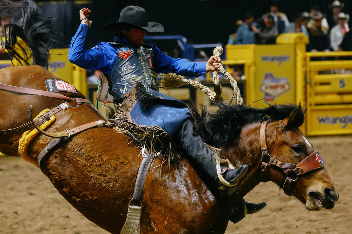 Stetson Wright rides Cracker Jack in the saddle bronc riding event during the seventh go-round ...