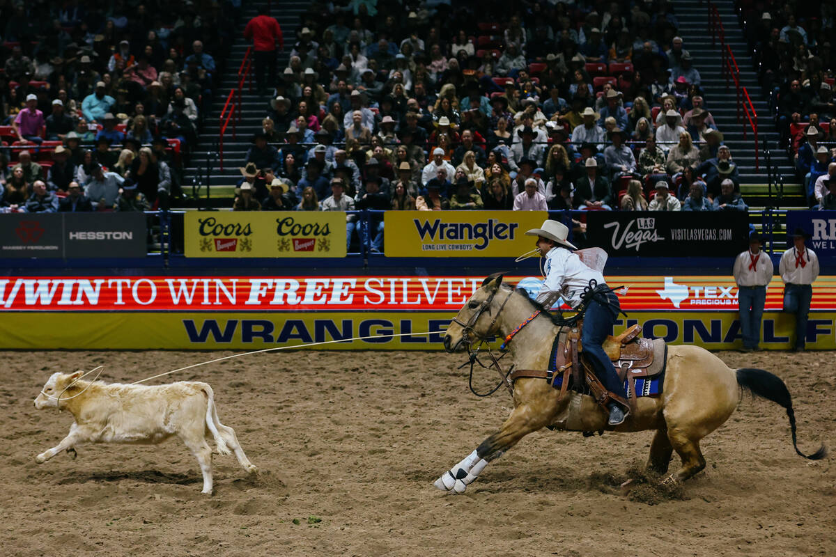 Ty Harris competes in the tie down roping event during the seventh go-round of the National Fin ...
