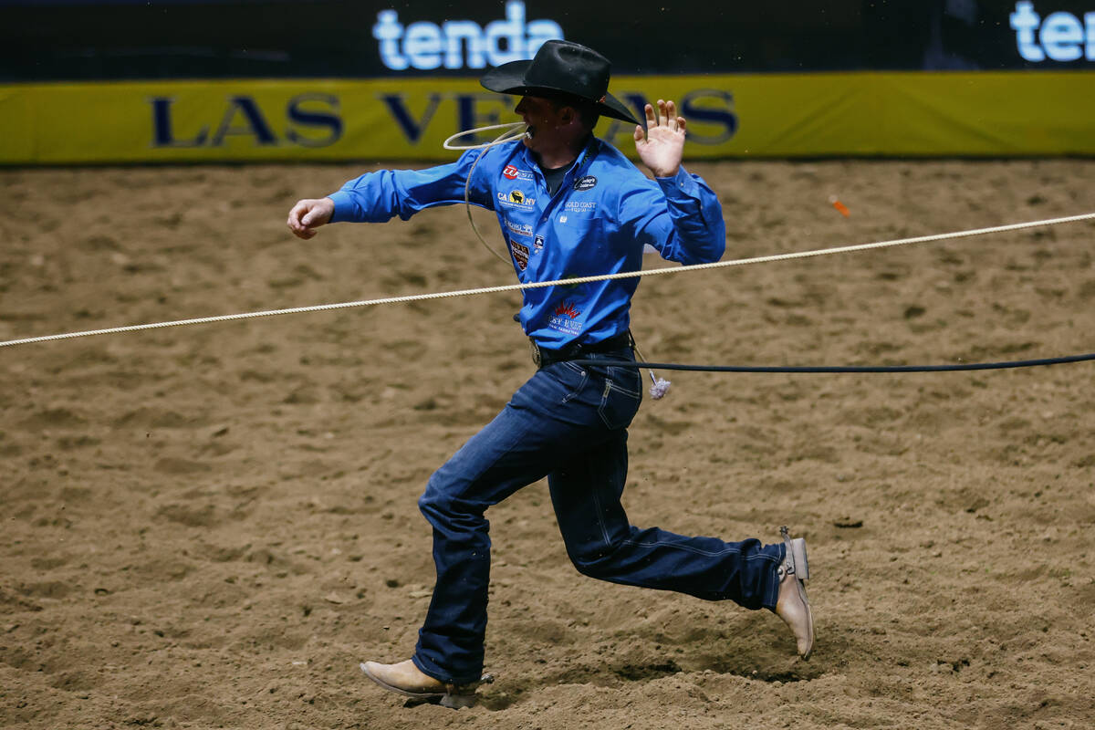 Brushton Minton competes in the tie down roping event during the seventh go-round of the Nation ...