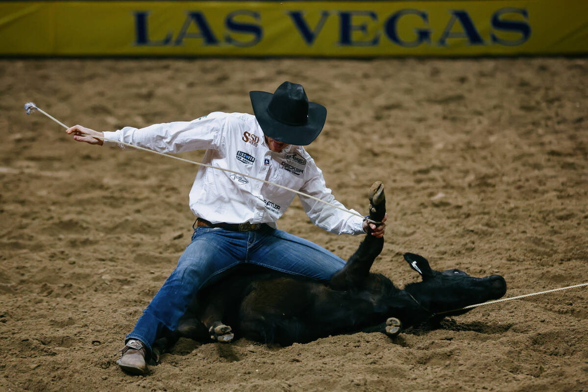 Joel Harris competes in the tie down roping event during the seventh go-round of the National F ...
