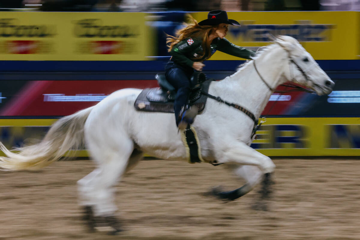 Emily Beisel competes in the barrel racing event during the seventh go-round of the National Fi ...