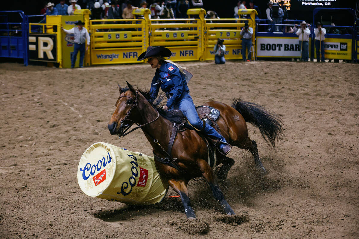 Wenda Johnson knocks down a barrel while competing in the barrel racing event during the sevent ...