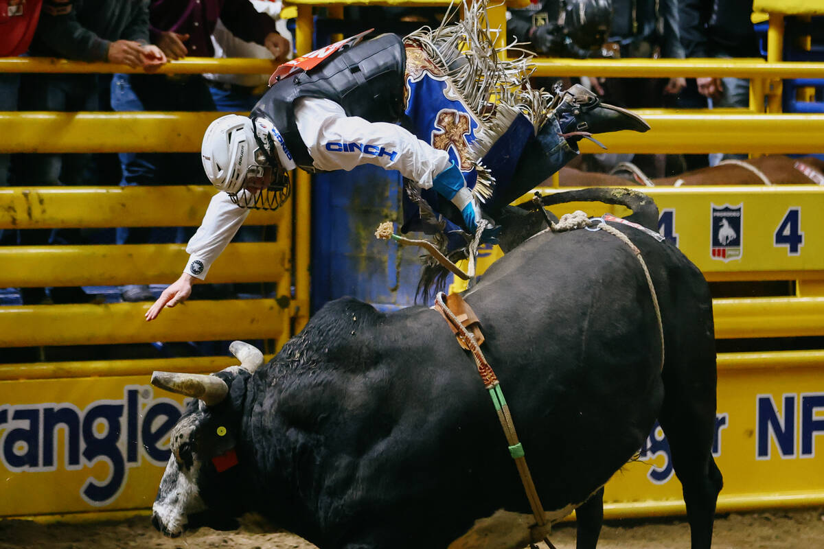 Mason Moody falls off of Hang’em High in the bull riding event during the seventh go-rou ...