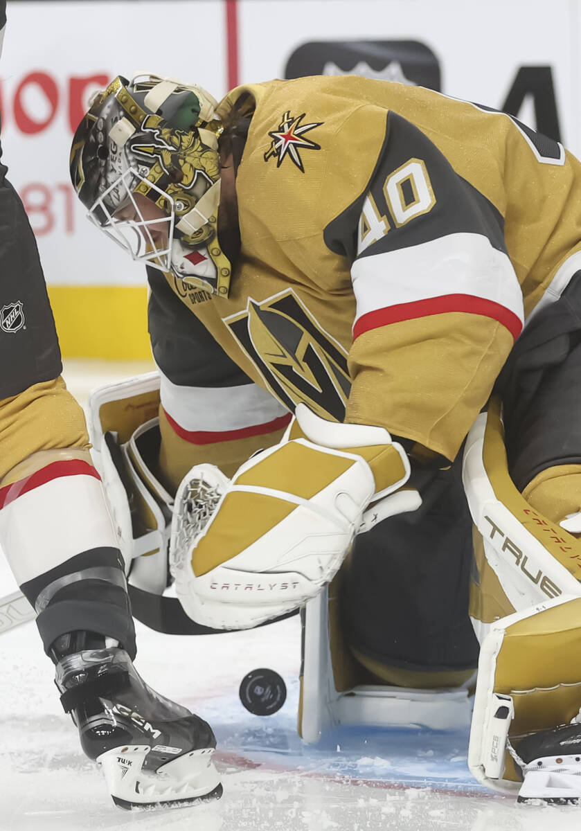 Golden Knights goaltender Akira Schmid (40) stops the puck during the second period of an NHL h ...