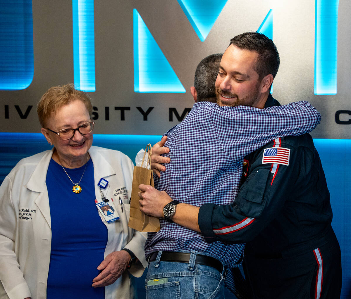 Carmen Losito hugs helicopter paramedic Jeff Yost, who cared for him after he was shot in the c ...