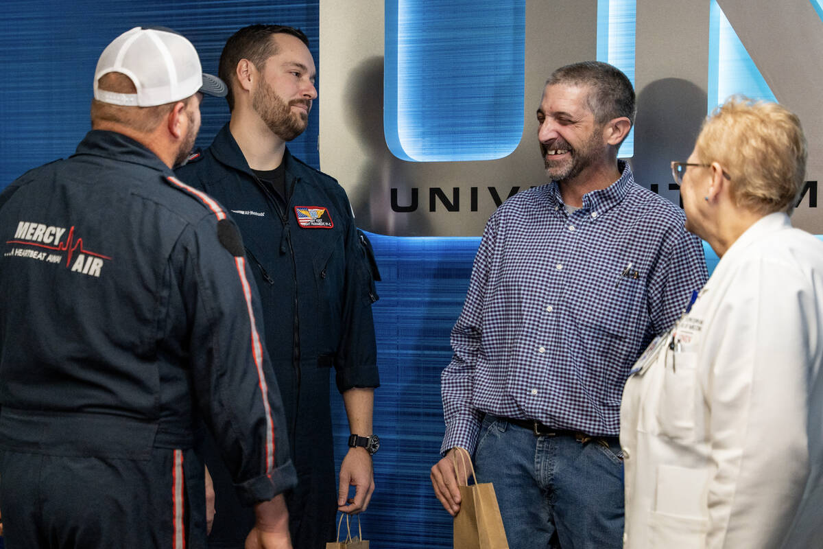 Carmen Losito chats with members of his care team at UMC Trauma Center in Las Vegas on Dec. 10, ...