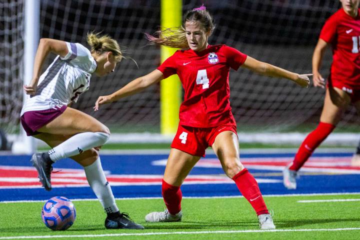 Faith Lutheran's Kloe Abdalla (14) attempts to get past Coronado's Ella Schultz (4) f ...