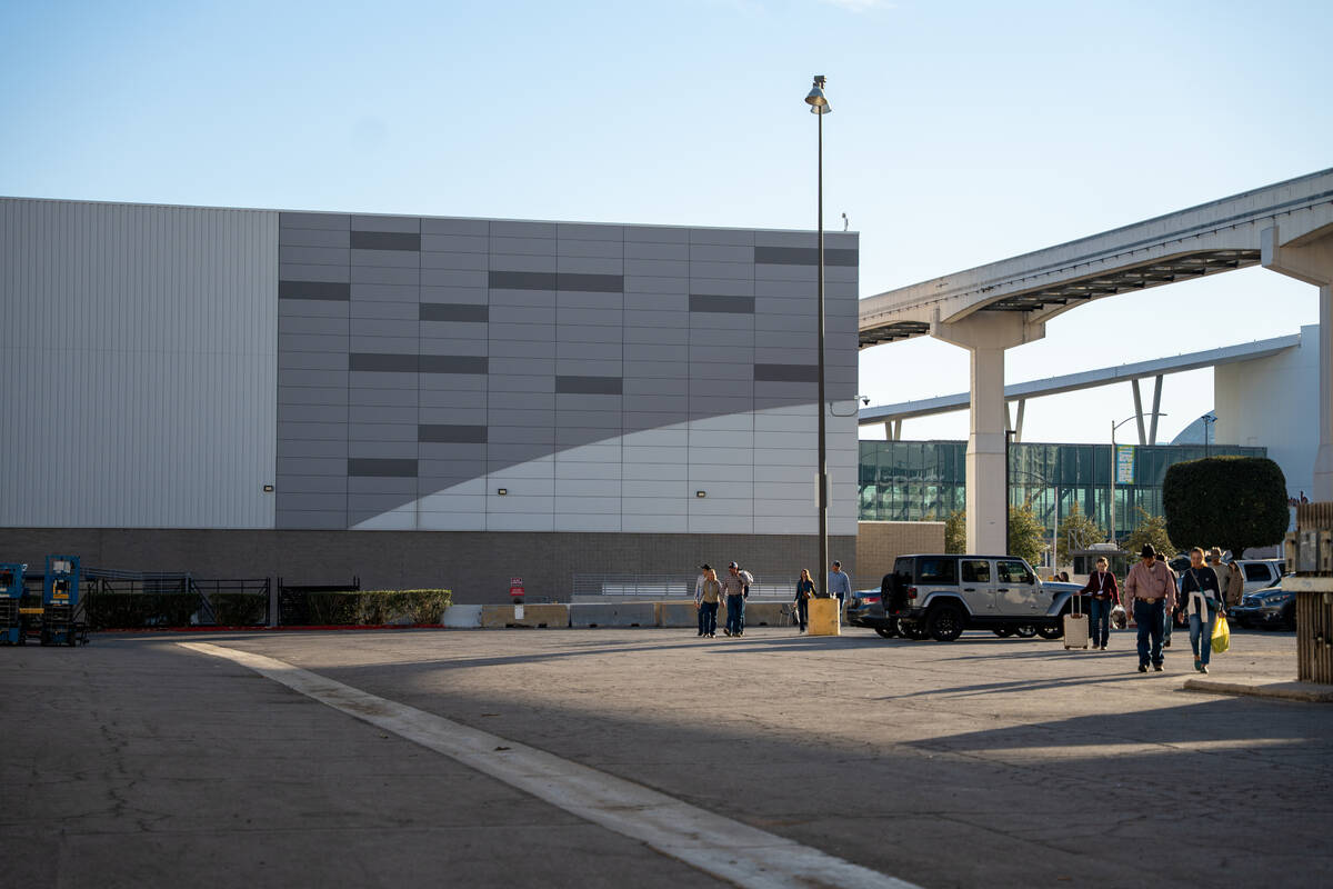 Visitors pass the side of the Las Vegas Convention Center after leaving Cowboy Christmas Tuesda ...