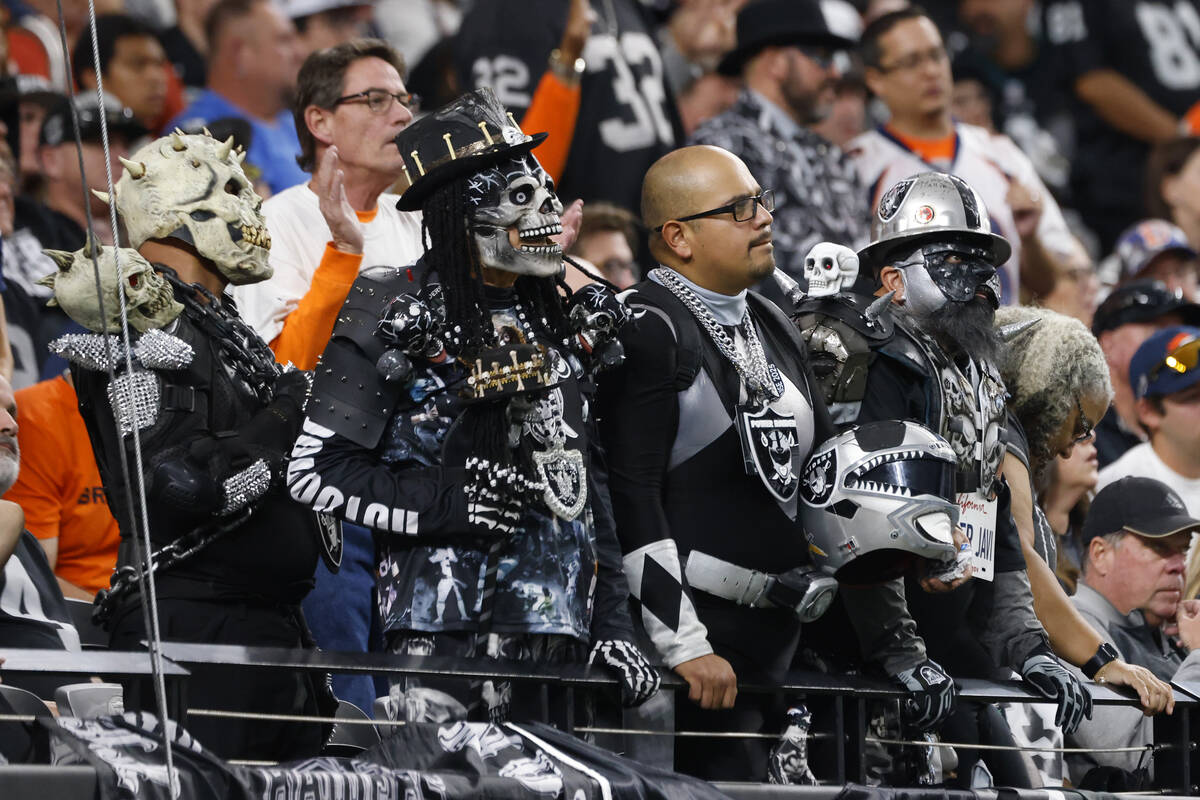Raiders fans watch their team during an NFL game against the Denver Broncos at the Allegiant St ...