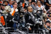Raiders fans watch their team during an NFL game against the Denver Broncos at the Allegiant St ...
