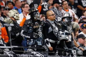 Raiders fans watch their team during an NFL game against the Denver Broncos at the Allegiant St ...