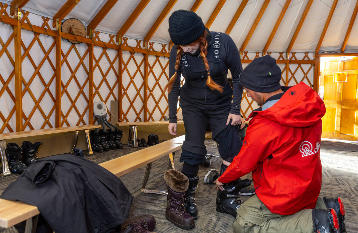 Heather Collins is fitted for ski boots with the help of instructor Cole O'Connell at Lee ...