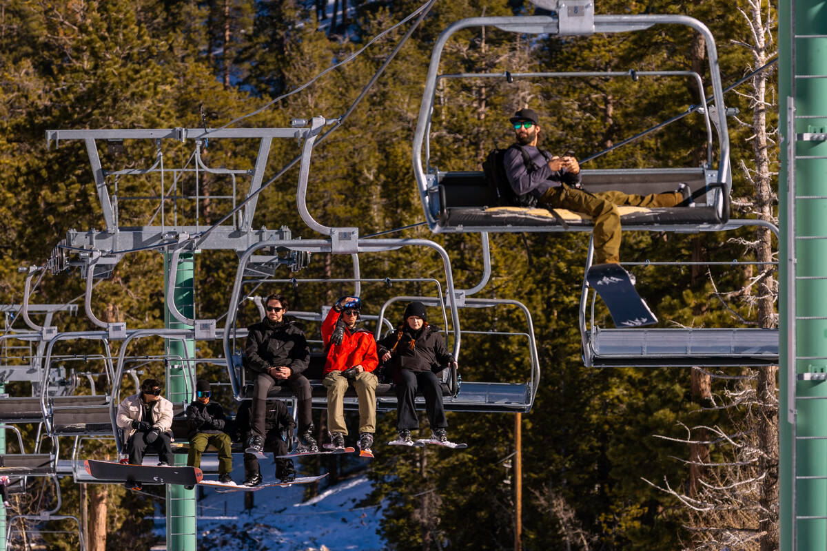 Ski instructor Cole O'Connell, center, rides a lift with Frank Stucki, left, and Heather C ...