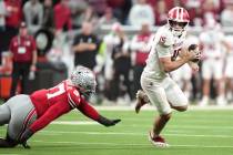 Indiana's Fernando Mendoza scrambles pasr Ohio State's Kenyatta Jackson Jr. during th ...