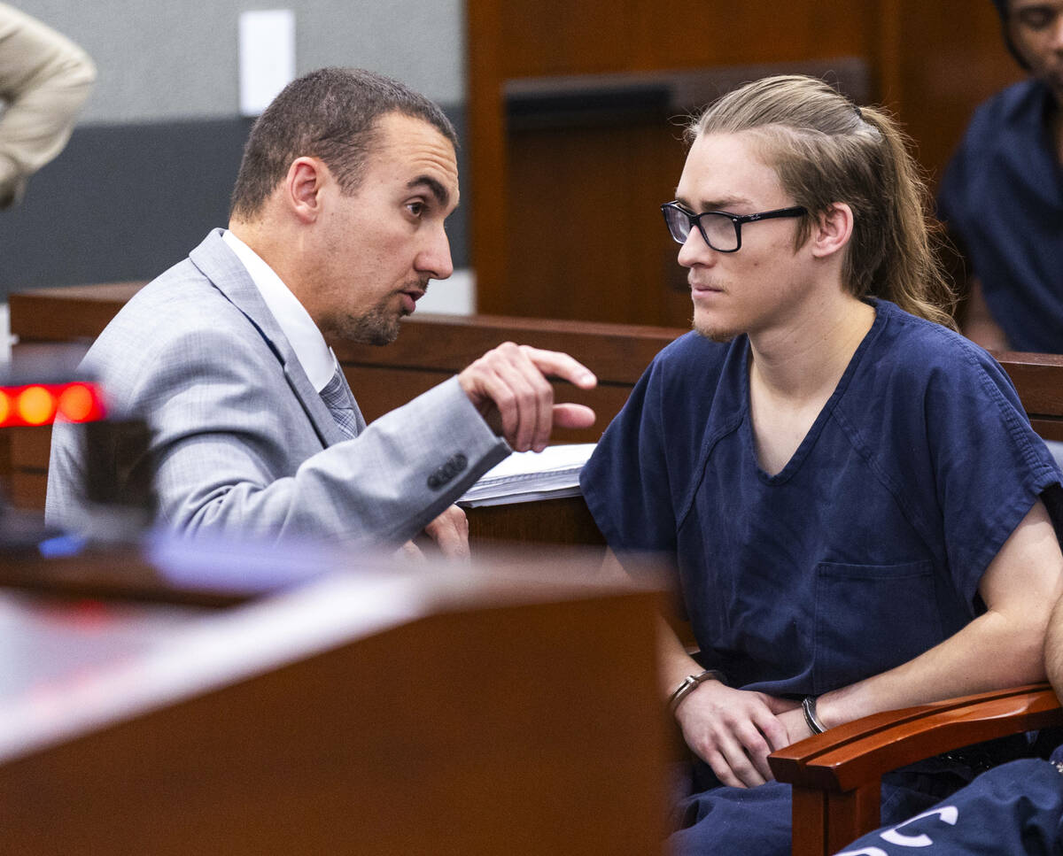 Attorney Ryan Helmick speaks with his client Tyler Johns during an initial arraignment before J ...