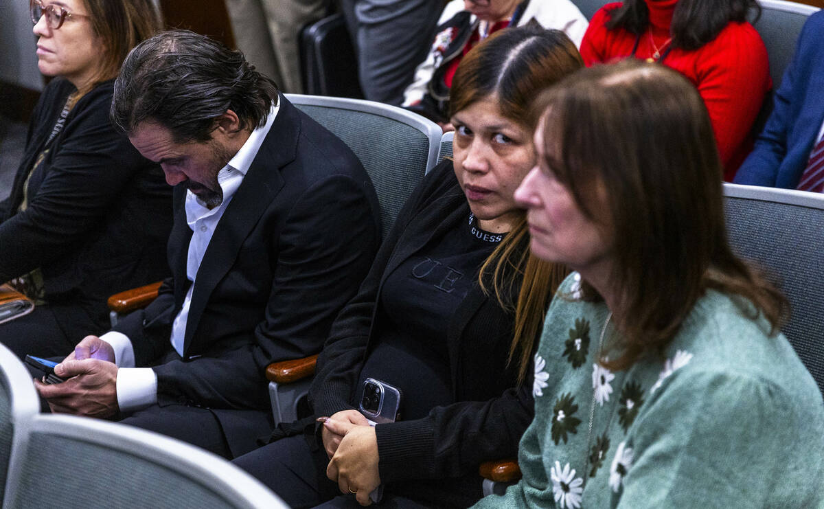 Rubi Chavarria, center, the mother of 11-year-old Brandon Dominguez-Chavarria, attends an initi ...