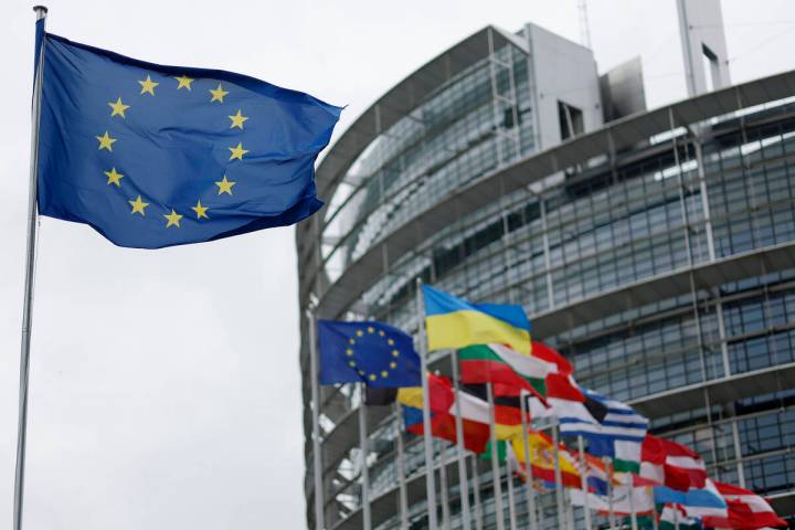FILE - The European flag, left, flies at the European Parliament in Strasbourg, eastern France. ...