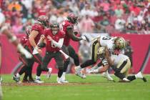 Tampa Bay Buccaneers quarterback Baker Mayfield (6) spins out tackle attempts during an NFL foo ...