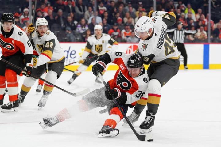 Philadelphia Flyers' Emil Andrae, center, is tripped by Vegas Golden Knights' Ivan Barbashev (4 ...