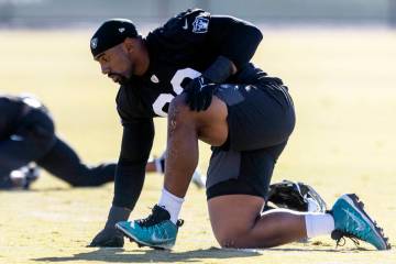 Raiders defensive tackle Thomas Booker (99) stretches during the team’s practice at the ...