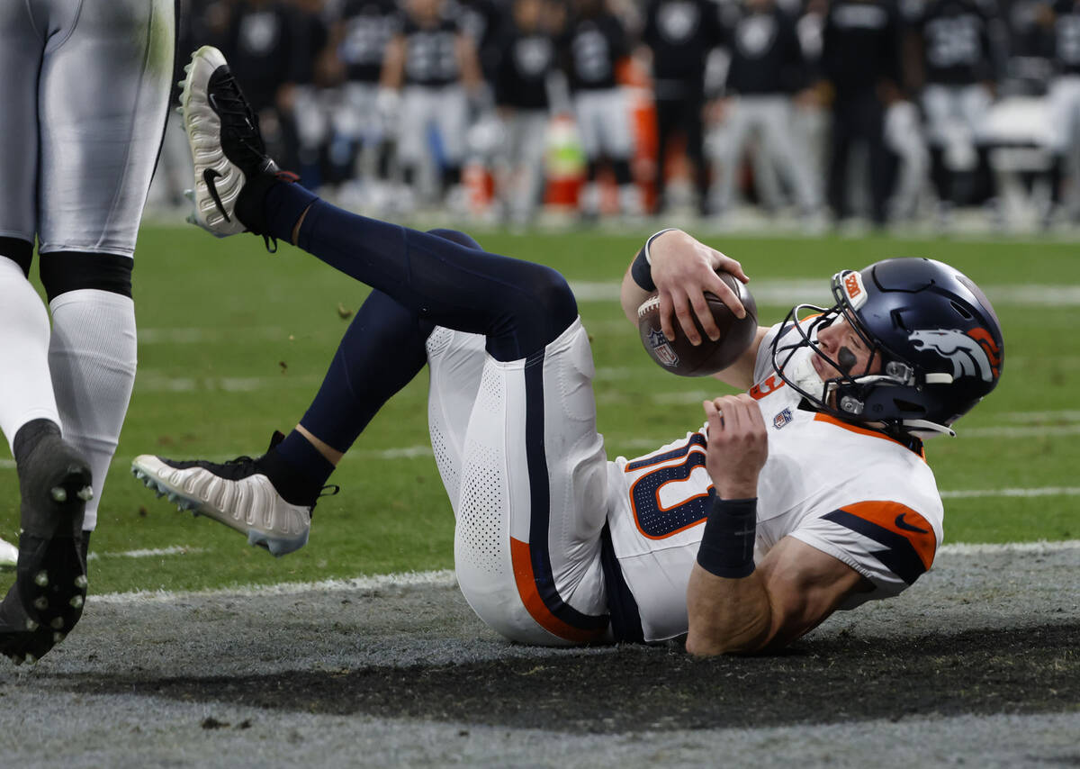 Denver Broncos quarterback Bo Nix (10) scores a touchdown during the first half of an NFL game ...