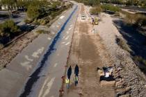 Work on a new trail, right, is underway on the north side of Summerlin Parkway on Friday, Dec. ...