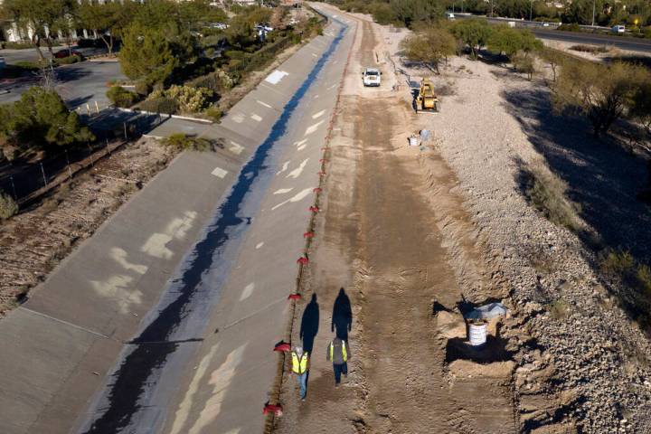 Work on a new trail, right, is underway on the north side of Summerlin Parkway on Friday, Dec. ...