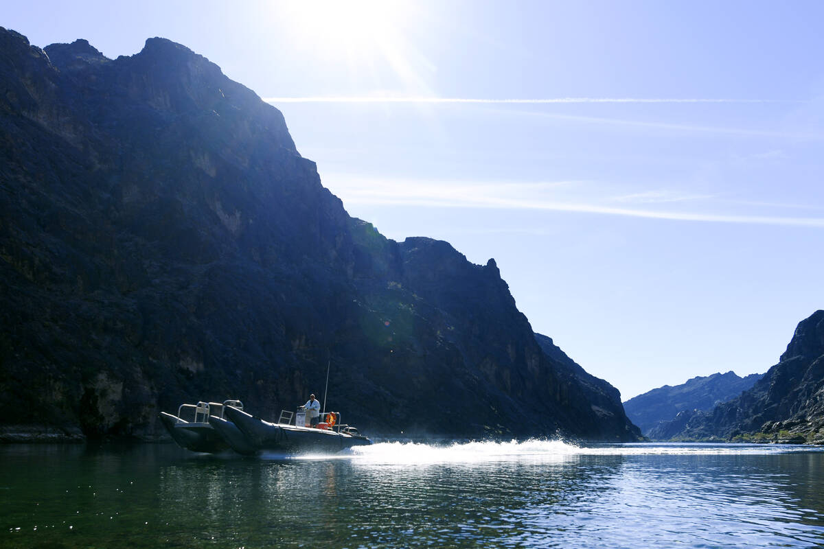 A motorized raft travels upstream on the Colorado River south of Hoover Dam on Oct. 19, 2025. ( ...