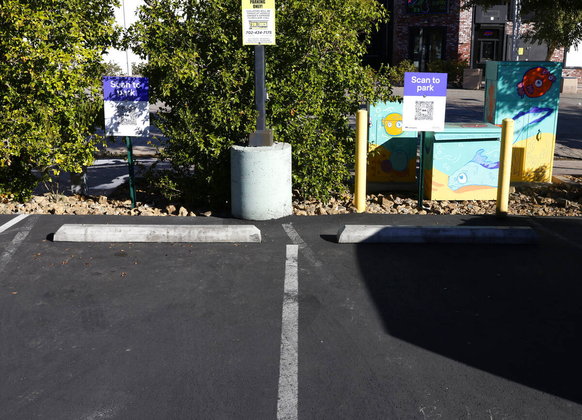 Scan to park signs are posted at 1 East Charleston Blvd. parking lot on Friday, Dec. 12, 2025, ...