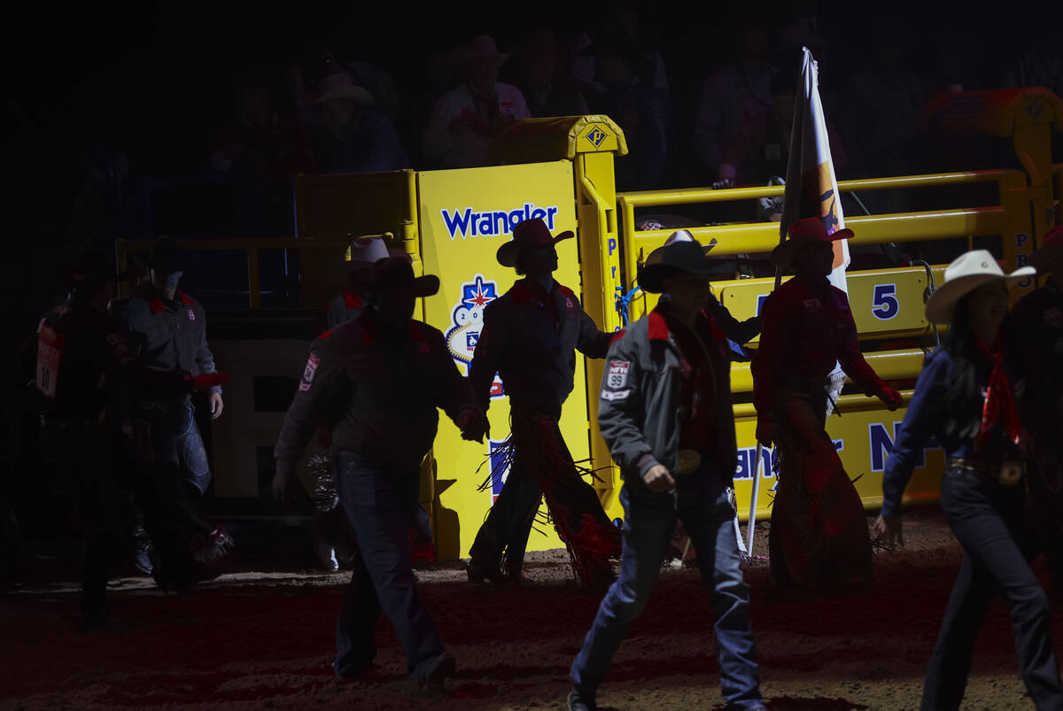 Contestants are introduced at the start of the eighth go-round of the National Finals Rodeo at ...