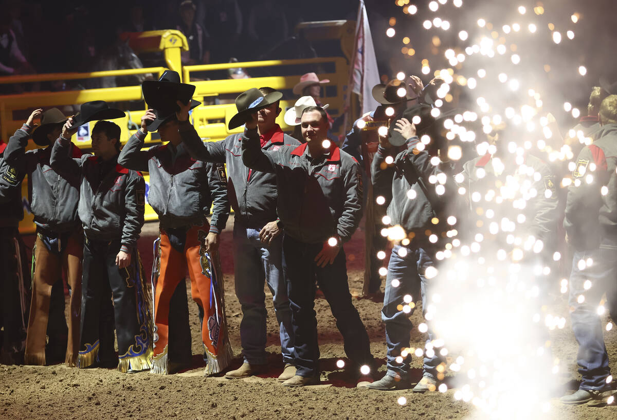 Contestants are introduced at the start of the eighth go-round of the National Finals Rodeo at ...