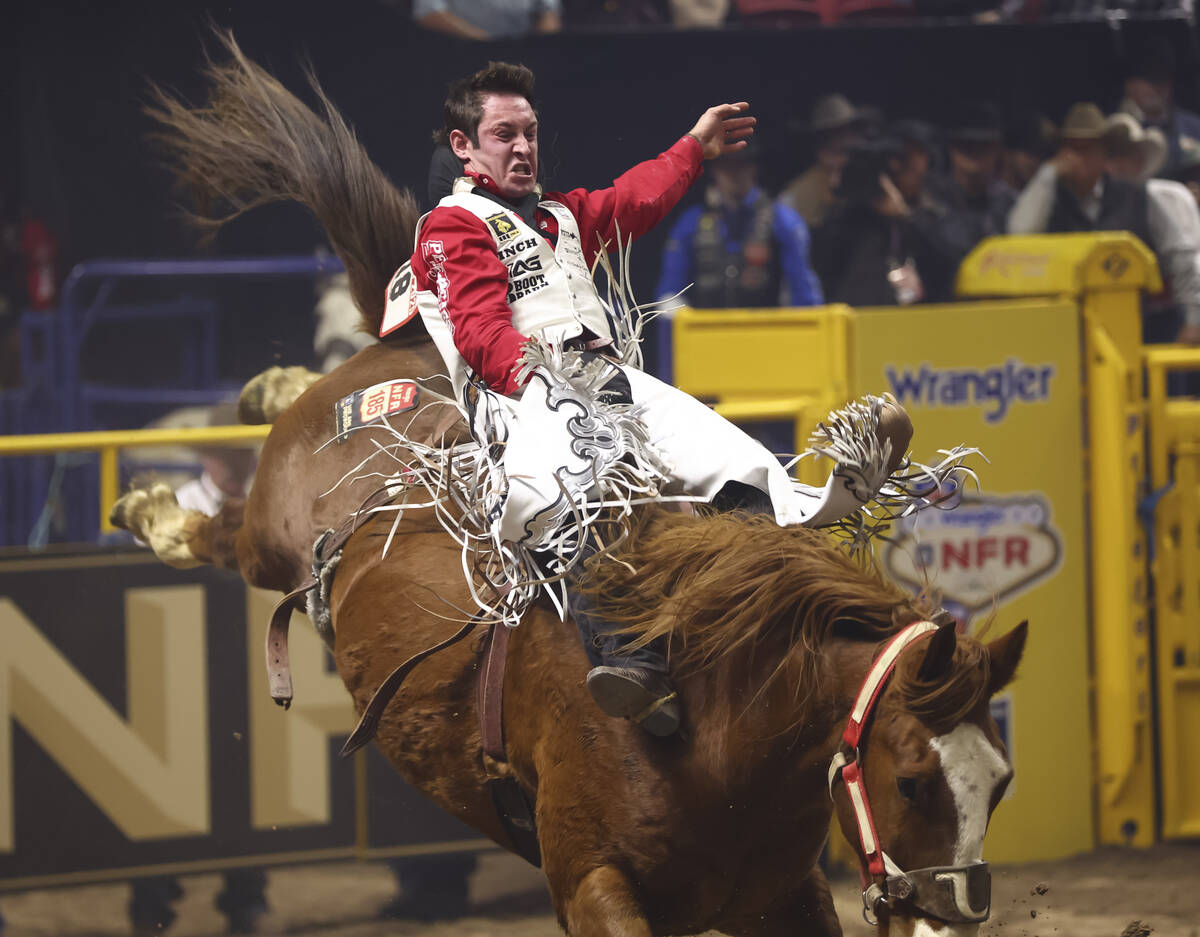 Cole Franks rides Right On Q while competing in bareback riding during the eighth go-round of t ...