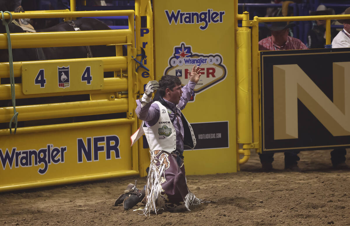 Waylon Bourgeois reacts after competing in bareback riding during the eighth go-round of the Na ...