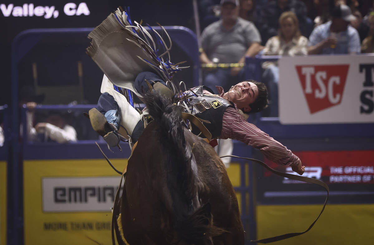 Jacek Frost rides Mighty High while competing in bareback riding during the eighth go-round of ...